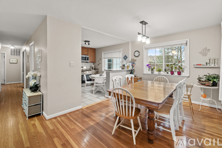 A dining room with a wooden table and chairs.
