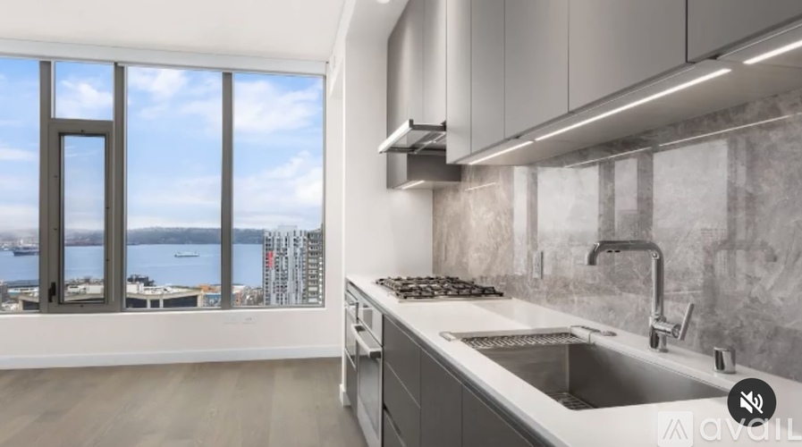 A modern kitchen with a large window overlooking a body of water.