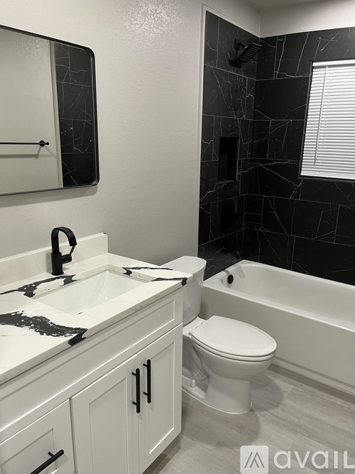 A bathroom with a white toilet and a white sink.