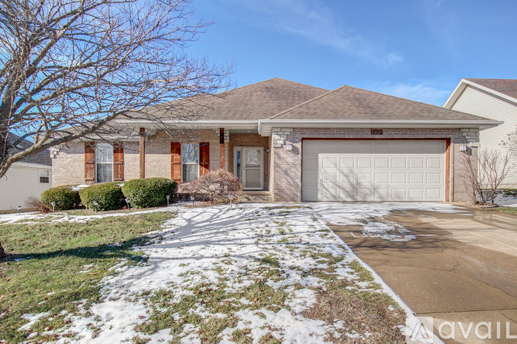 A house with a brown roof and a white garage door.