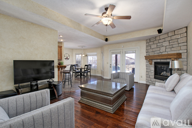 A living room with a grey couch, a coffee table, and a fireplace.