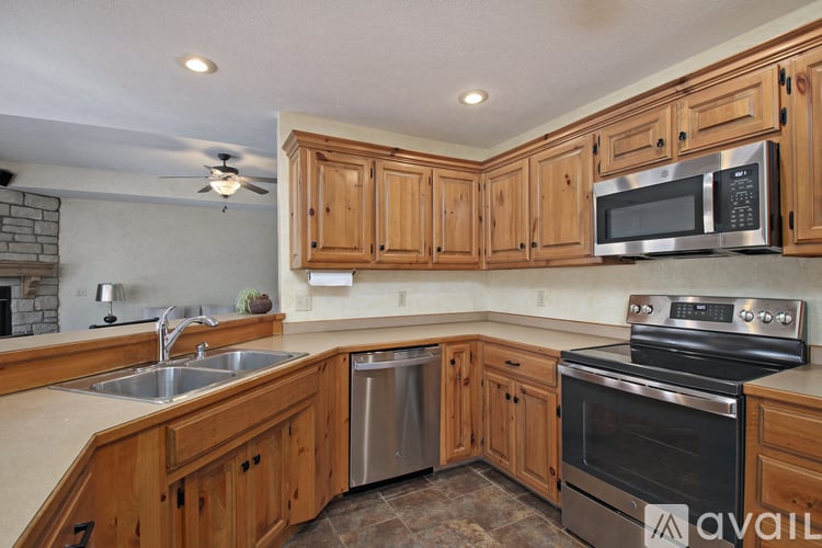A kitchen with wooden cabinets and stainless steel appliances.