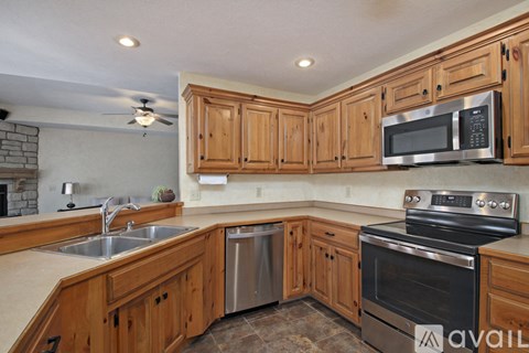 A kitchen with wooden cabinets and stainless steel appliances.