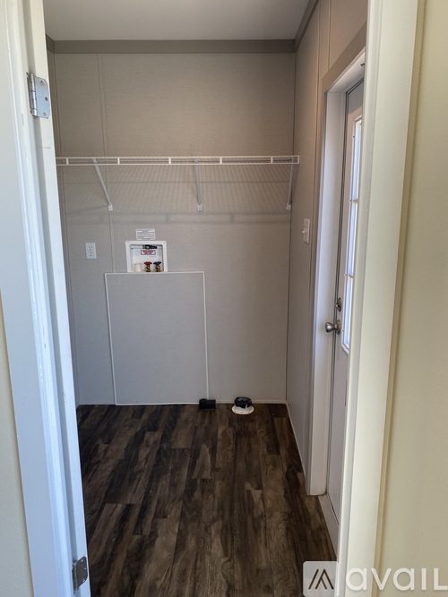 A small room with a white door and a white cabinet.
