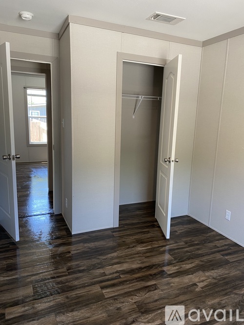 A room with a wooden floor and white walls.