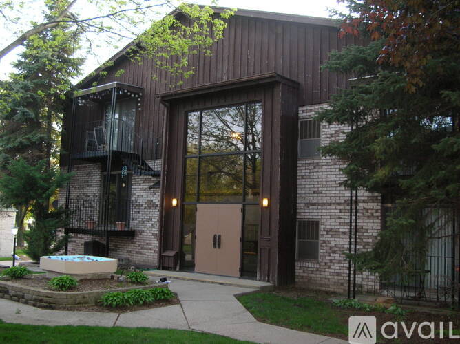 A modern house with a balcony and a glass door.