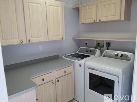 A kitchen with white cabinets and a white oven.