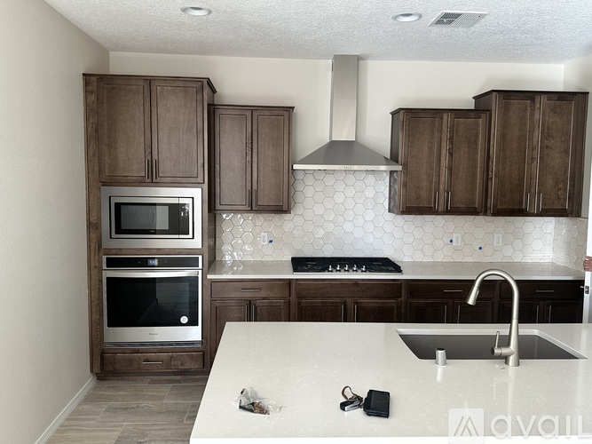 A kitchen with brown cabinets and a white countertop.
