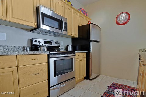 A kitchen with wooden cabinets and stainless steel appliances.