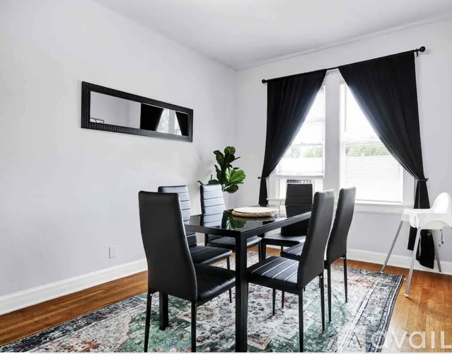 A dining room with a table set for four.