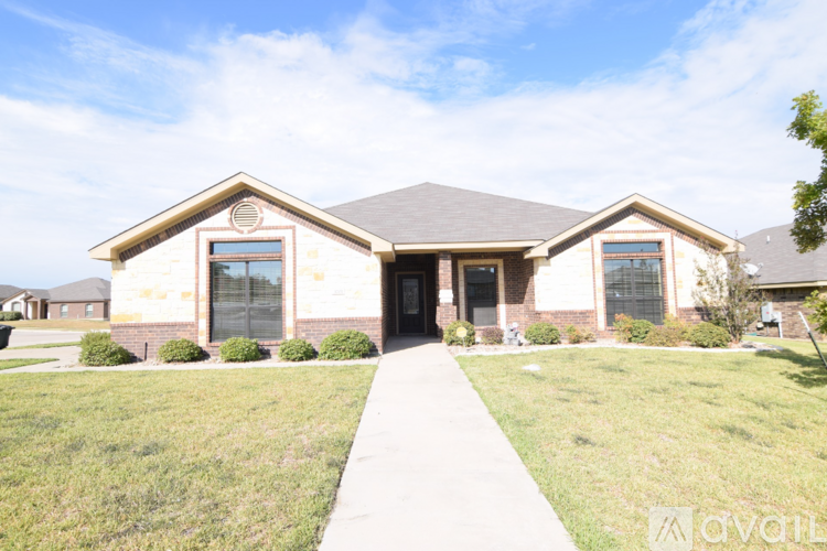 A house with a front yard and a walkway leading to the front door.