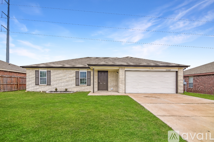 A house with a garage and a driveway in front.