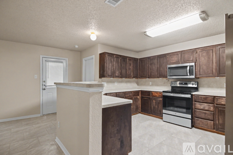 A kitchen with wooden cabinets and a white countertop.