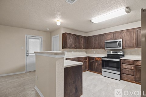 A kitchen with wooden cabinets and a white countertop.