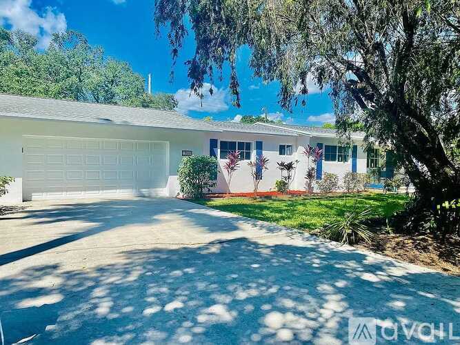 A house with a white garage door and a driveway.