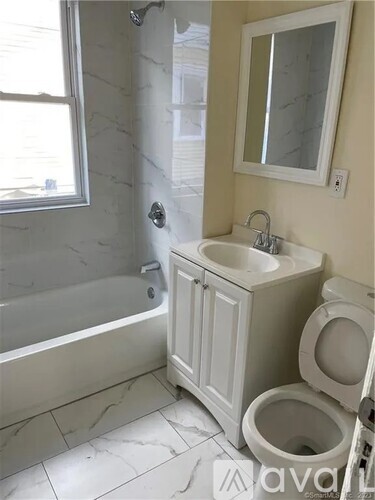 A white bathroom with a toilet and sink.