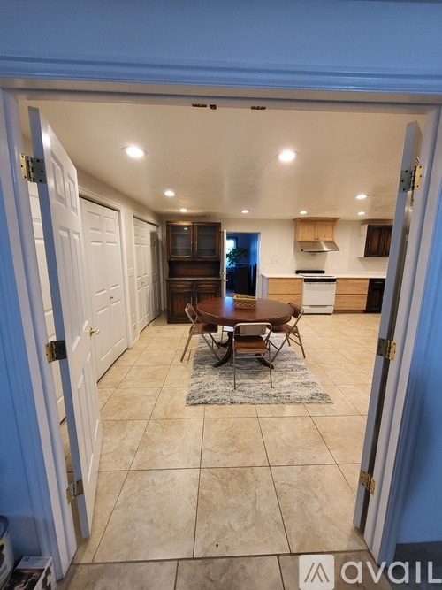 A dining room with a table set for four.