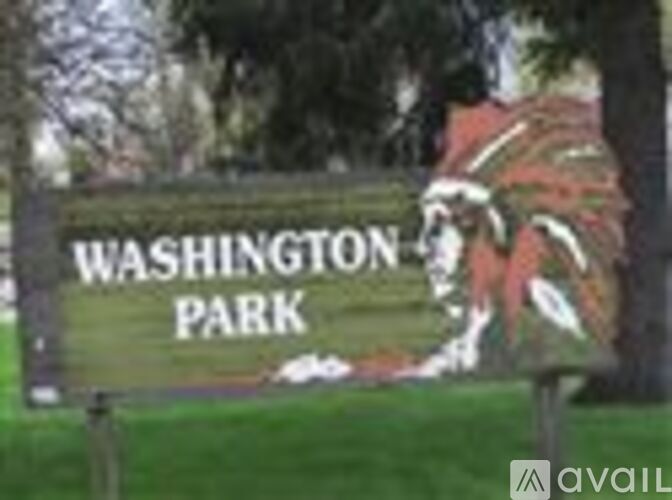 A sign for Washington Park with a Native American headdress on it.