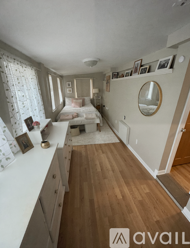 A bedroom with a bed, dresser, and mirror.