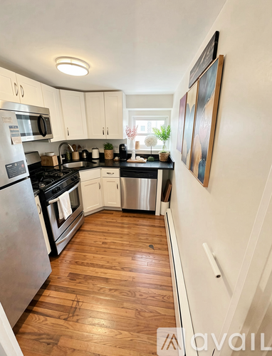 A kitchen with wooden floors and stainless steel appliances.