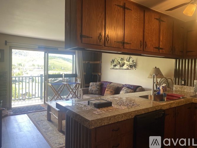 A kitchen with wooden cabinets and a marble countertop.