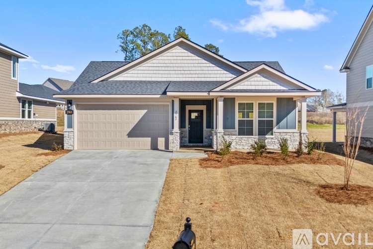 A house with a grey roof and a black door is available for sale.