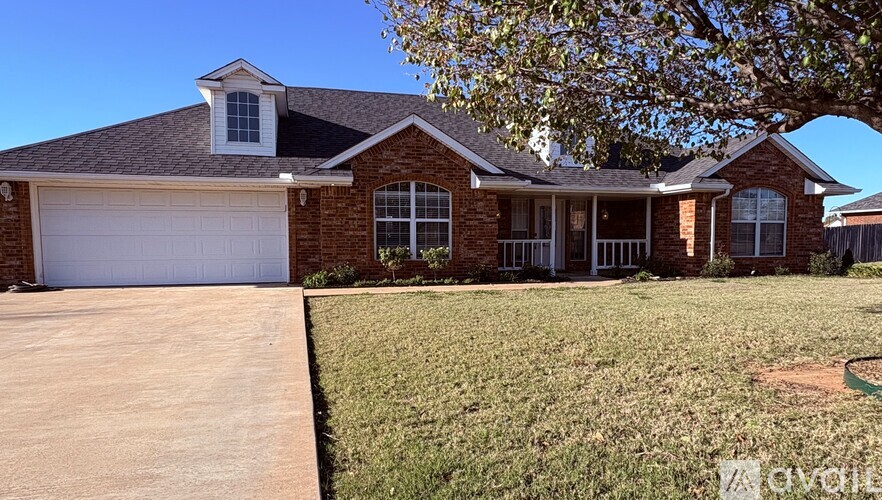 A house with a white garage door and a brown roof.