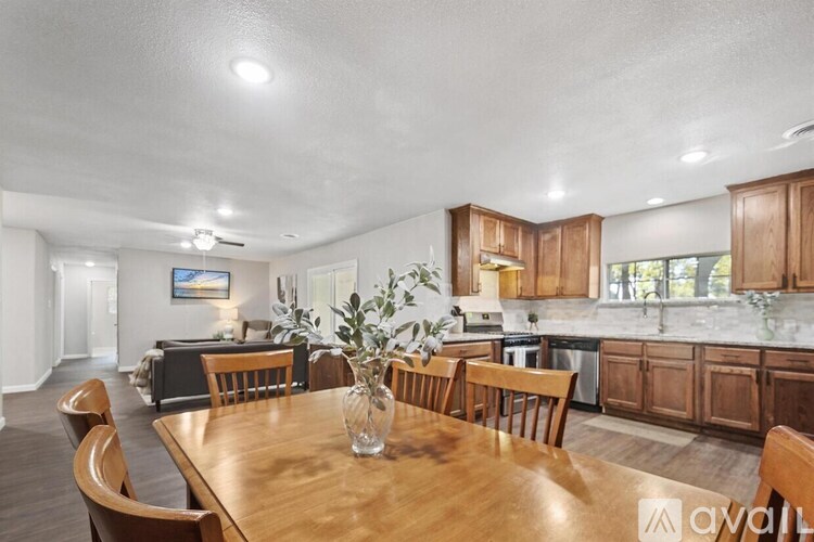 A dining room with a wooden table and chairs.