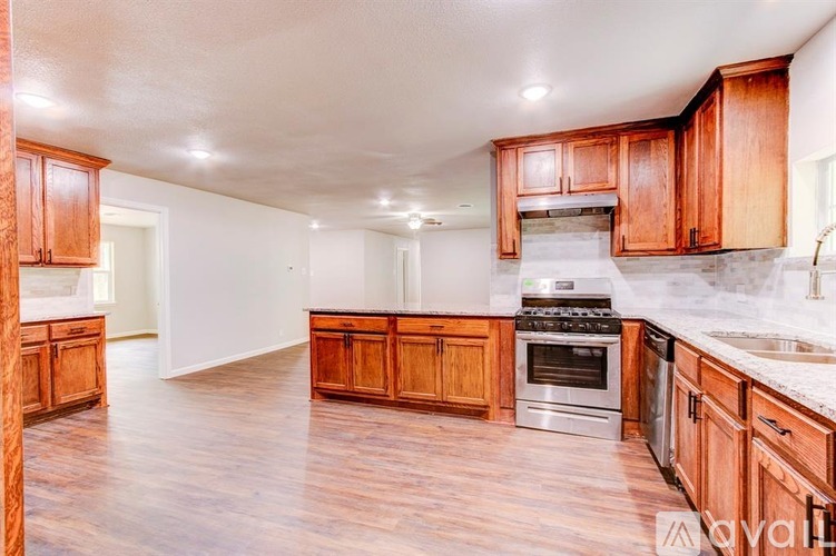 A kitchen with wooden cabinets and stainless steel appliances.