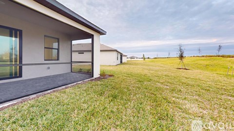 A house with a grassy yard in front of it.