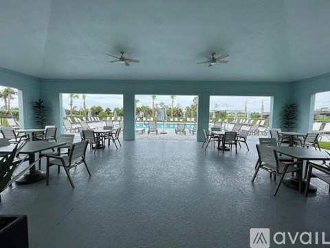 A spacious outdoor dining area with multiple tables and chairs.