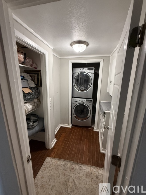 A small laundry room with a washer and dryer.