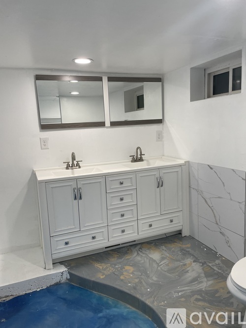 A bathroom with a white vanity and a blue pool.