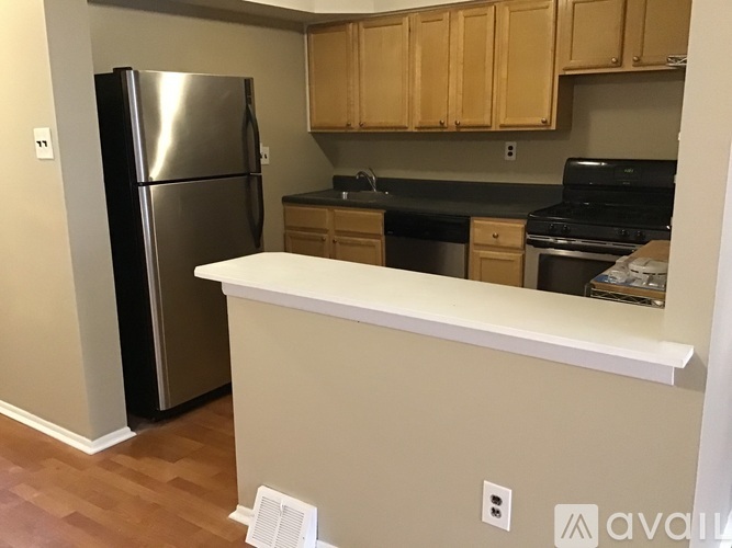 A kitchen with a refrigerator, stove, and oven.