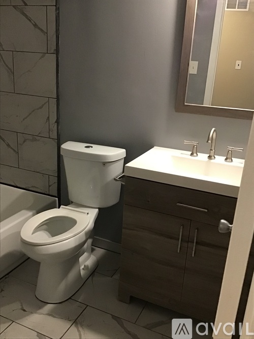 A white toilet sits next to a sink in a bathroom.