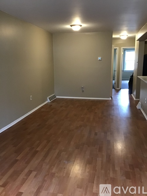 A room with wooden flooring and a light on the ceiling.