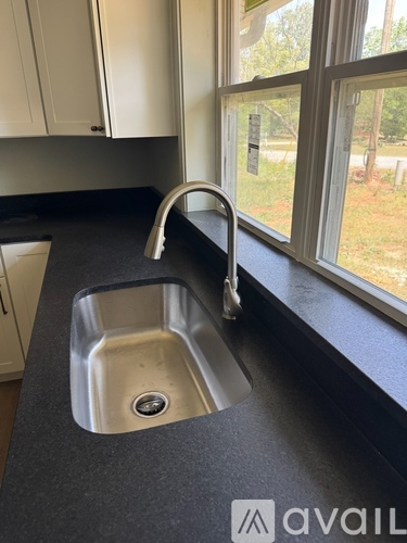 A kitchen sink with a chrome faucet.