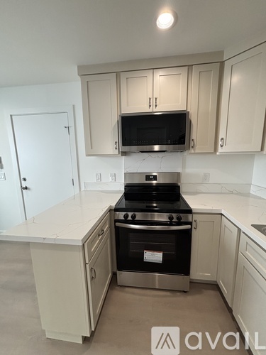 A kitchen with a stove top oven and microwave above it.