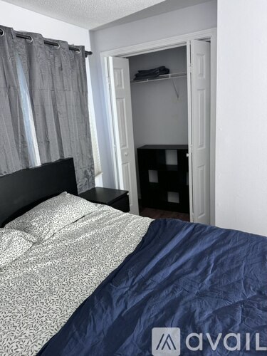 A bedroom with a bed and a closet.