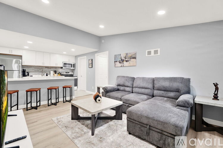 A modern living room with a grey sofa and a coffee table.