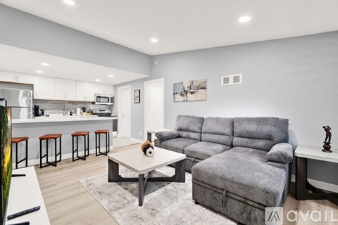 A modern living room with a grey sofa and a coffee table.