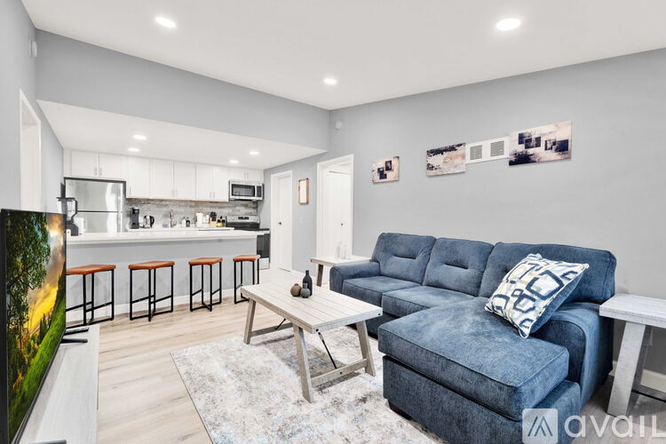 A living room with a blue couch and a television.
