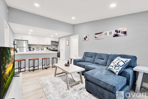 A living room with a blue couch and a television.