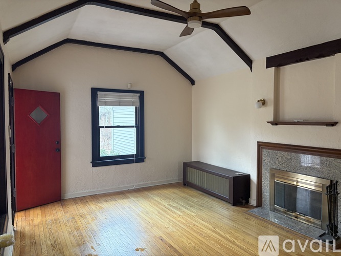 A room with a fireplace and a ceiling fan.