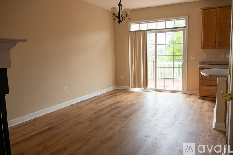 A room with wooden floors and a chandelier.