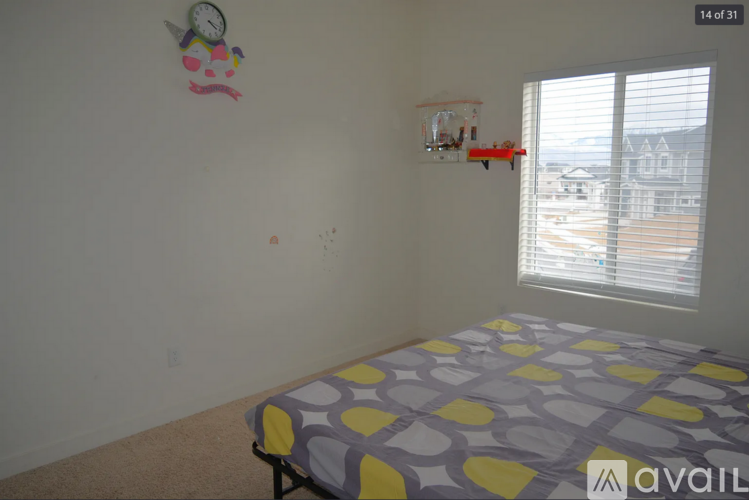 A bedroom with a bed and a wall hanging.