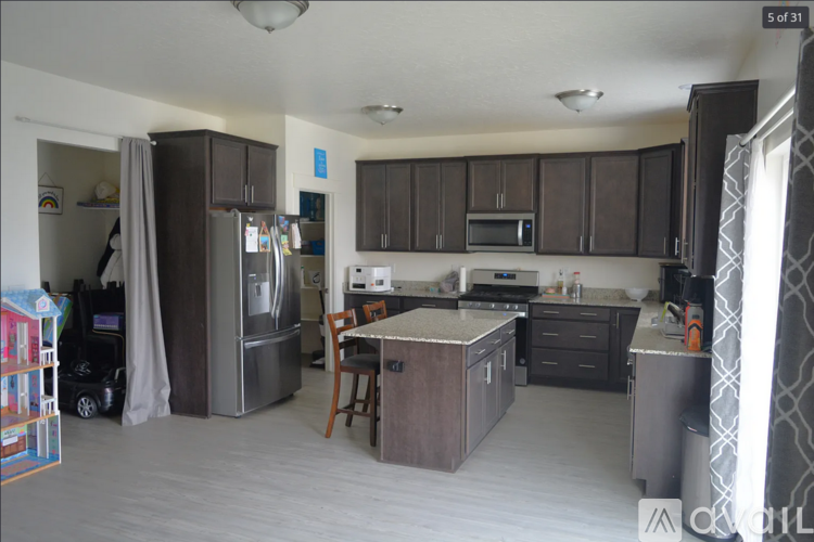 A kitchen with brown cabinets and a refrigerator.