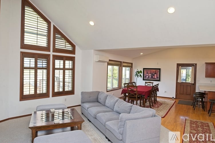 A living room with a grey couch and a wooden coffee table.