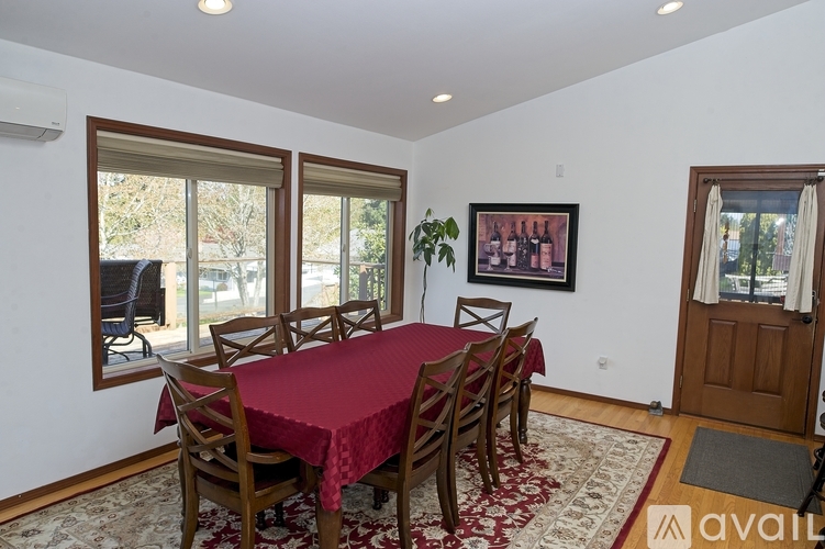 A dining room with a table set for six.