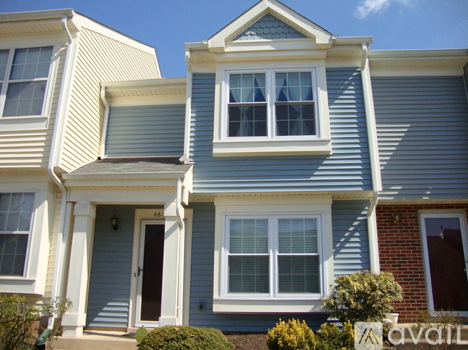 A two story house with a blue and white exterior.